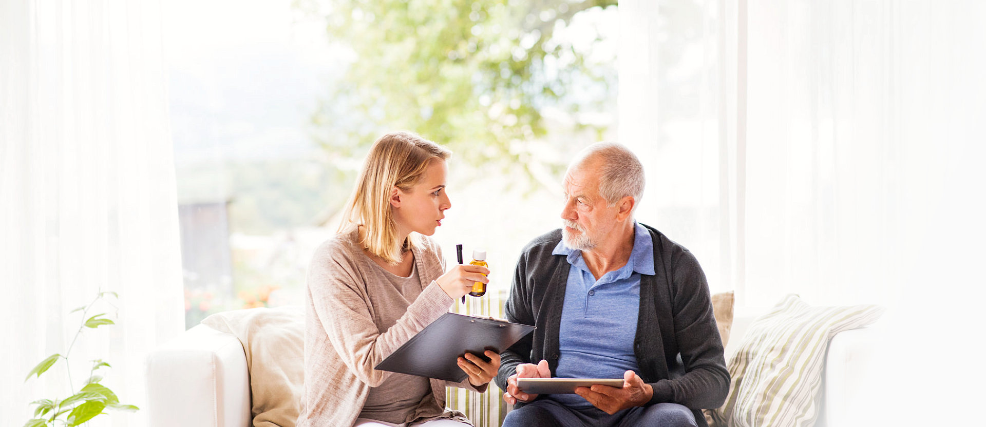 senior man and his caregiver discusiing medicine