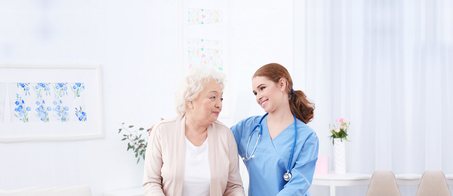 nurse smiling at her senior patient